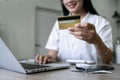 Young woman makes a purchase on the Internet on the laptop with credit card Royalty Free Stock Photo