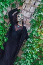 Young woman with Makeup of green skull for halloween surrounded by green leafs Royalty Free Stock Photo