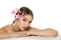 Young woman with makeup  posing with orchids Royalty Free Stock Photo