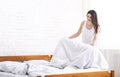 Young woman making bed alone in morning Royalty Free Stock Photo