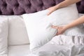 Young woman making bed Royalty Free Stock Photo