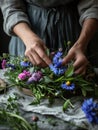 Young woman making a bouquet or a wreath of wildflowers and herbs. Florist making a decoration for midsummer. Generative AI Royalty Free Stock Photo