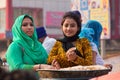 Young woman making chapati during Guru Nanak Gurpurab celebration in Delhi, India