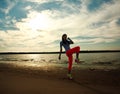 Young woman making fitness exercises on sand beach Royalty Free Stock Photo