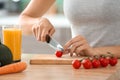 Young woman making fresh vegetable salad in kitchen, closeup Royalty Free Stock Photo