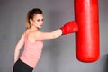 Young woman making a hard punch on punching bag Royalty Free Stock Photo