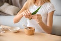 Young woman making healthy facial mask with aloe vera extract at home Royalty Free Stock Photo