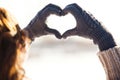 Young woman making heart symbol