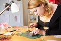 Young Woman Making Jewelry At Home