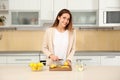 Young woman making lemon water