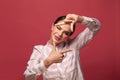 Young woman making photo frame with her hands over red background Royalty Free Stock Photo