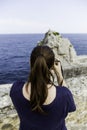 Young woman making photos to the sea Royalty Free Stock Photo