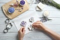 Young woman making  soap bar with lavender flowers on white wooden background, top view Royalty Free Stock Photo