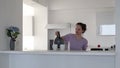 A young woman is making tea at the kitchen