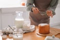 Young woman making traditional Easter cake in kitchen, closeup Royalty Free Stock Photo