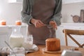 Young woman making traditional Easter cake in kitchen, closeup Royalty Free Stock Photo