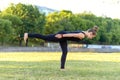 Young woman making vajra yoga virabhadrasana in pose of warrior