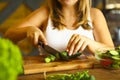 Young woman making vegetable salad Royalty Free Stock Photo