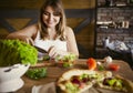 Young woman making vegetable salad Royalty Free Stock Photo