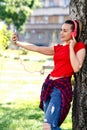 Young woman making video call via smartphone and headphones