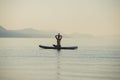 Young woman making a yoga asana position with her hands joined above her head Royalty Free Stock Photo