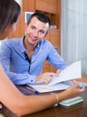 Young woman and man with financial documents in agency Royalty Free Stock Photo