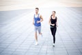 Young woman and man jogging in city copy space Royalty Free Stock Photo