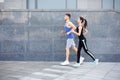 Young woman and man jogging in city copy space Royalty Free Stock Photo