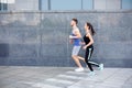 Young woman and man jogging in city copy space Royalty Free Stock Photo