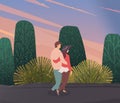 Young woman and man in love, hugging each other, walking outdoor. Embraces of a loving couple Royalty Free Stock Photo