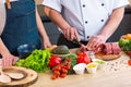 Young woman and man prepare food and host a cooking show. The bloggers stream from modern kitchen. Healthy food Royalty Free Stock Photo