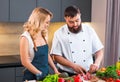 Young woman and man prepare food and host a cooking show. The bloggers stream from modern kitchen. Healthy food Royalty Free Stock Photo