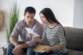 Young woman and man reading an open document. Royalty Free Stock Photo