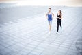 Young woman and man running in city copy space Royalty Free Stock Photo