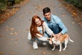 Young woman and man taking off dog`s lead Royalty Free Stock Photo