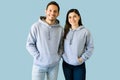 Young woman and man with trendy hoodies