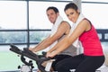 Young woman and man working out at spinning class Royalty Free Stock Photo