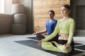 Young woman and man in yoga class, relax meditation pose Royalty Free Stock Photo