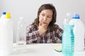 Young woman and cleaning products