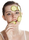 Young woman with mask from slice of a cucumber Royalty Free Stock Photo