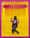 Young woman with mask on swing with yellow background