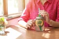 Young woman with mason jar of natural lemonade in cafe, closeup. Detox drink Royalty Free Stock Photo