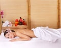 Young woman on massage table in beauty spa. Royalty Free Stock Photo