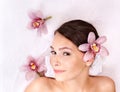 Young woman on massage table in beauty spa. Royalty Free Stock Photo