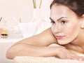 Young woman on massage table in beauty spa. Royalty Free Stock Photo