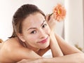 Young woman on massage table in beauty spa. Royalty Free Stock Photo