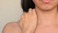 Young woman massaging her neck due to osteoporosis, scoliosis or wearing heaviness