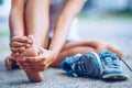 Young woman massaging her painful foot from exercising Royalty Free Stock Photo