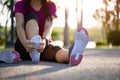 Young woman massaging her painful foot while exercising. Running Sport and excercise injury concept Royalty Free Stock Photo