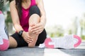 Young woman massaging her painful foot while exercising. Running Sport and excercise injury concept